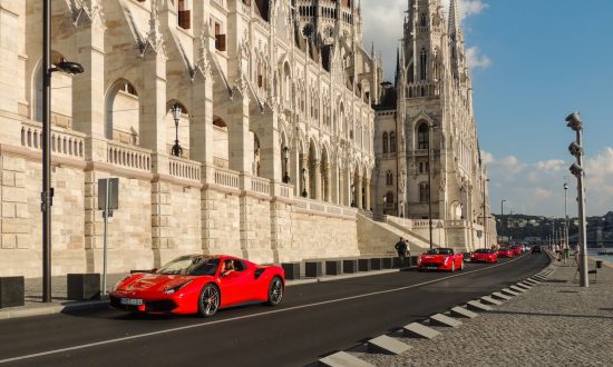 red ferrari 458 italia parked near white concrete building during daytime