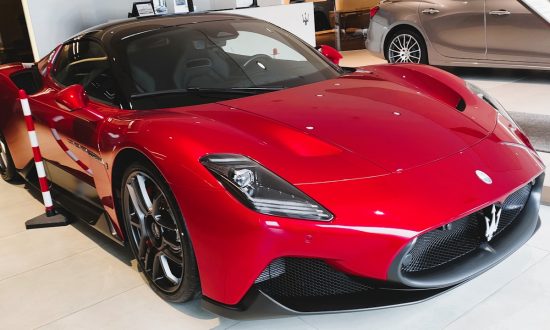a red sports car is on display in a showroom